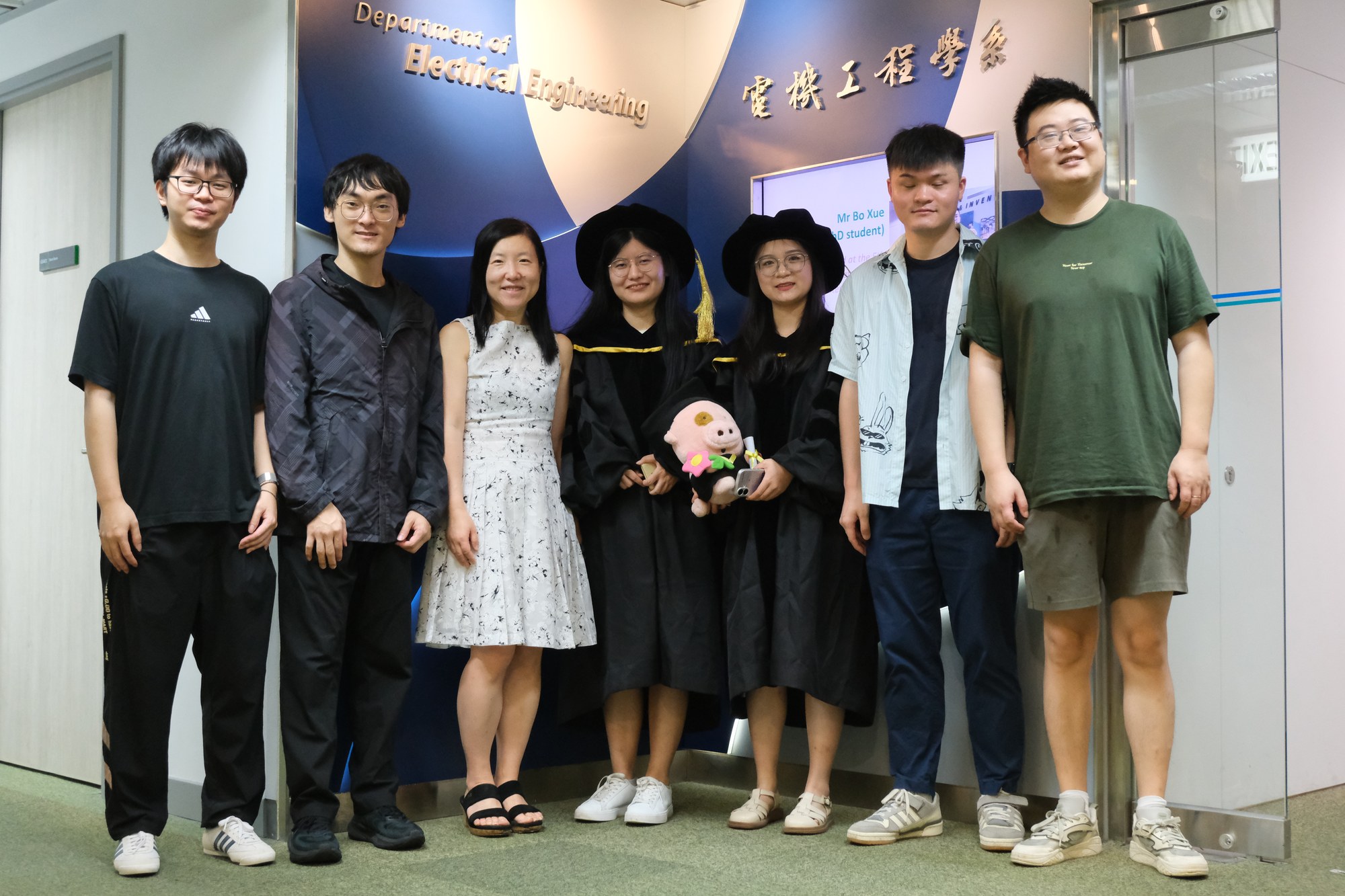 Research students, graduates, faculty, and guests celebrating together in June 2026