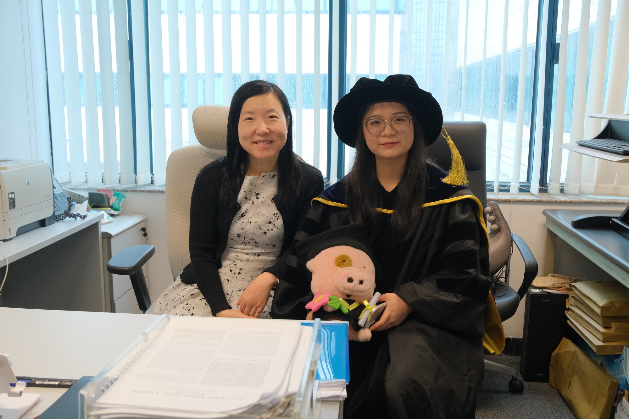 Professor Lin Dai with a graduating research student in her office